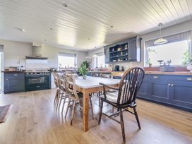 A kitchen with a dining table and chairs at Cutbush Farmhouse in Hingham