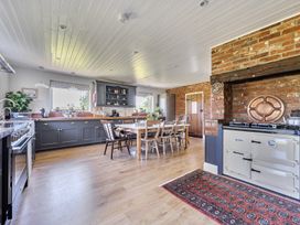 A kitchen with a dining table and chairs at Cutbush Farmhouse in Hingham