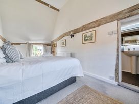 A bedroom with a bed and window at Cutbush Farmhouse in Hingham