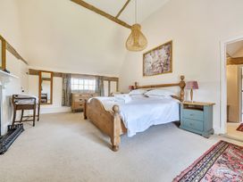 A bedroom with a bed and bedside table at Cutbush Farmhouse Hingham