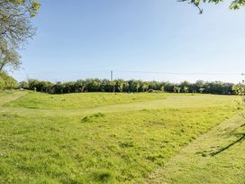 An outdoor space with grass and trees at Cutbush Farmhouse in Hingham