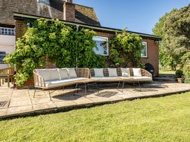 Outdoor seating area with a sofa and a table at Cutbush Farmhouse Hingham