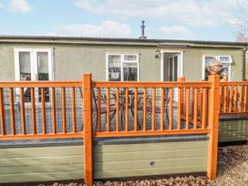 An outdoor area with a wooden deck and seating at The Nest Lodge 55 Grantham