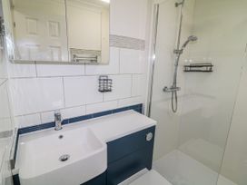 A bathroom with a sink and shower at The Nest Lodge 55 Grantham