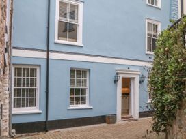 Exterior view of a blue wall with windows and door at Dennings House, Mayors Avenue in Dartmouth