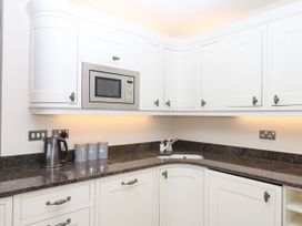 A kitchen with a kettle and microwave at Dennings House, Mayors Avenue in Dartmouth