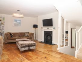 A living room with a sofa and television at Dennings House, Mayors Avenue in Dartmouth