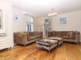 A living room with sofas and a bookshelf at Dennings House, Mayors Avenue, Dartmouth