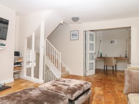 A living room with a staircase and desk at Dennings House, Mayors Avenue in Dartmouth