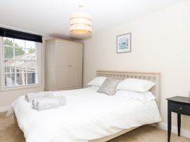 A bedroom with a bed and wardrobe at Dennings House, Mayors Avenue in Dartmouth