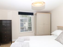 A bedroom with a bed and wardrobe at Dennings House, Mayors Avenue Dartmoor