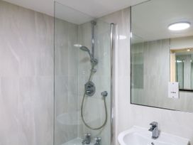 A bathroom with a shower and sink at Dennings House, Mayors Avenue, Dartmouth