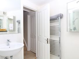 A bathroom with a wash basin and towel rack at Dennings House, Mayors Avenue, Dartmouth