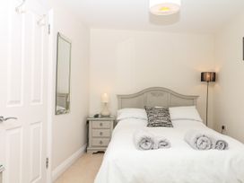 A bedroom with a bed and nightstand at Dennings House, Mayors Avenue, Dartmouth