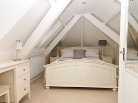 A bedroom with a bed and dresser at Dennings House, Mayors Avenue Dartmouth