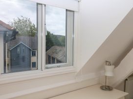 A bedroom with a window showing outside buildings at Dennings House, Mayors Avenue in Dartmouth