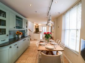 A kitchen with a dining table and chairs at Dennings House, Mayors Avenue, Dartmouth