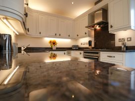 A kitchen with cabinets and a stove at Dennings House, Mayors Avenue in Dartmouth