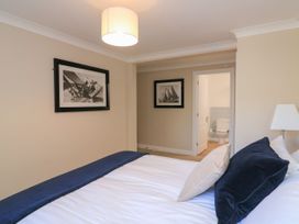 A bedroom with a bed and artwork on the wall at 6 Dartmouth House in Dartmouth