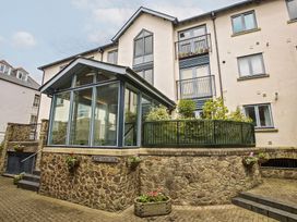A glass extension with a garden area and stone wall at 6 Dartmouth House, Dartmouth