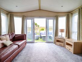 A living room with a sofa and table at Pemberton Knightsbridge in Morfa Bychan