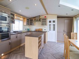 A kitchen with cabinets and appliances at Pemberton Knightsbridge in Morfa Bychan