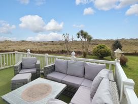 A patio with outdoor seating and a coffee table at Pemberton Knightsbridge in Morfa Bychan