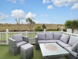 An outdoor patio with seating and a view at Pemberton Knightsbridge Morfa Bychan