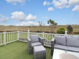 An outdoor seating area with chairs and a table at Pemberton Knightsbridge in Morfa Bychan