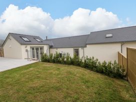 An outdoor view of a house with a garden at Dairy Cottage in Oxwich