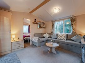 A living room with a sofa and coffee table at Prima -Kelling Heath Holiday Park in Holt