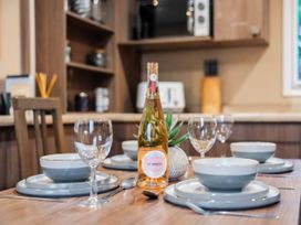 A dining table set with plates and glasses at The But n Ben - Kelling Heath Holiday Park, Holt