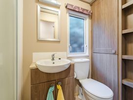 A bathroom with a sink and toilet at The But n Ben - Kelling Heath Holiday Park, Holt