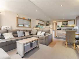 A living room with a kitchenette and seating area at Rawsons Retreat - Kelling Heath Holiday Park, Holt
