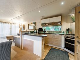 A kitchen with a counter and appliances at Rawsons Retreat - Kelling Heath Holiday Park, Holt