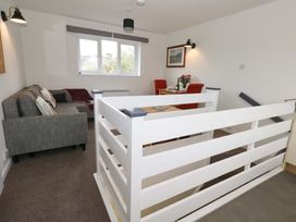 A living room with a sofa and dining area at Amber House in Dorchester