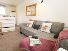 A living room with a sofa and table at Amber House in Dorchester
