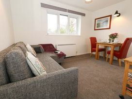 A living room with a sofa and dining table at Amber House in Dorchester
