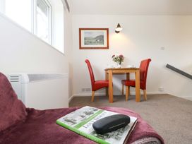 A dining area with a table and chairs at Amber House Dorchester