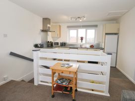 A kitchen with appliances and a table at Amber House in Dorchester