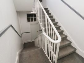 A staircase with a handrail and a door at Time Out in Whitby