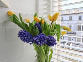 A bouquet of tulips and hyacinths in a glass vase at Time Out in Whitby