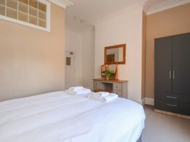 A bedroom with a bed and a mirror at Time Out in Whitby
