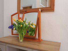 A mirror with flowers on a table at Time Out in Whitby