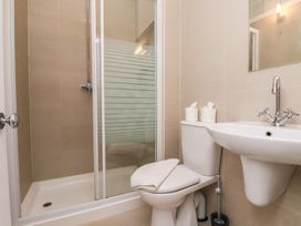 A bathroom with a shower, toilet, and sink at Time Out in Whitby