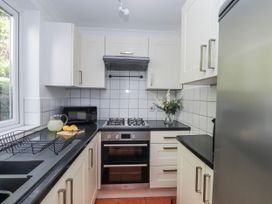 A kitchen with appliances and a sink at The Arches in Torquay