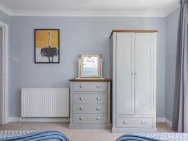 A bedroom with a wardrobe and chest of drawers at The Arches in Torquay