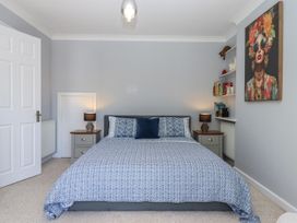 A bedroom with a bed and shelf at The Arches in Torquay