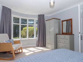 A bedroom with a bed and a wardrobe at The Arches in Torquay