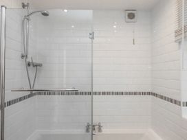 A bathroom with a shower and bathtub at The Arches in Torquay